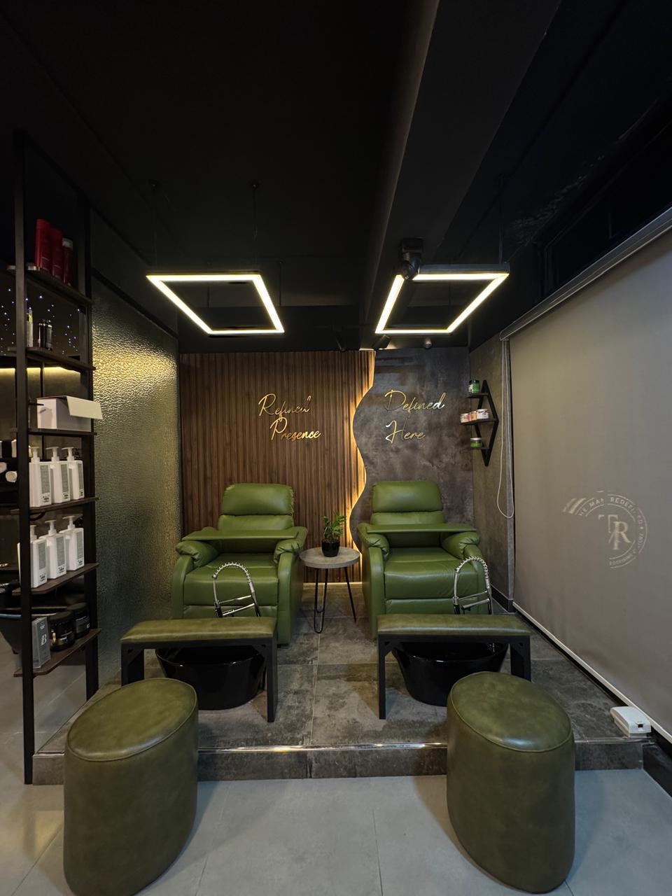 Mani-pedi lounge with green leather recliners and pedicure basins at The Man Redefined